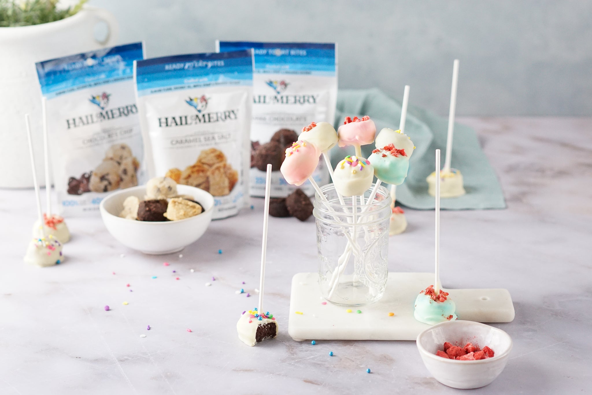 Coconut cookie dough pops dipped in vegan white chocolate topped with sprinkles and freeze-dried strawberries.  They are vegan, gluten-free and non-GMO.