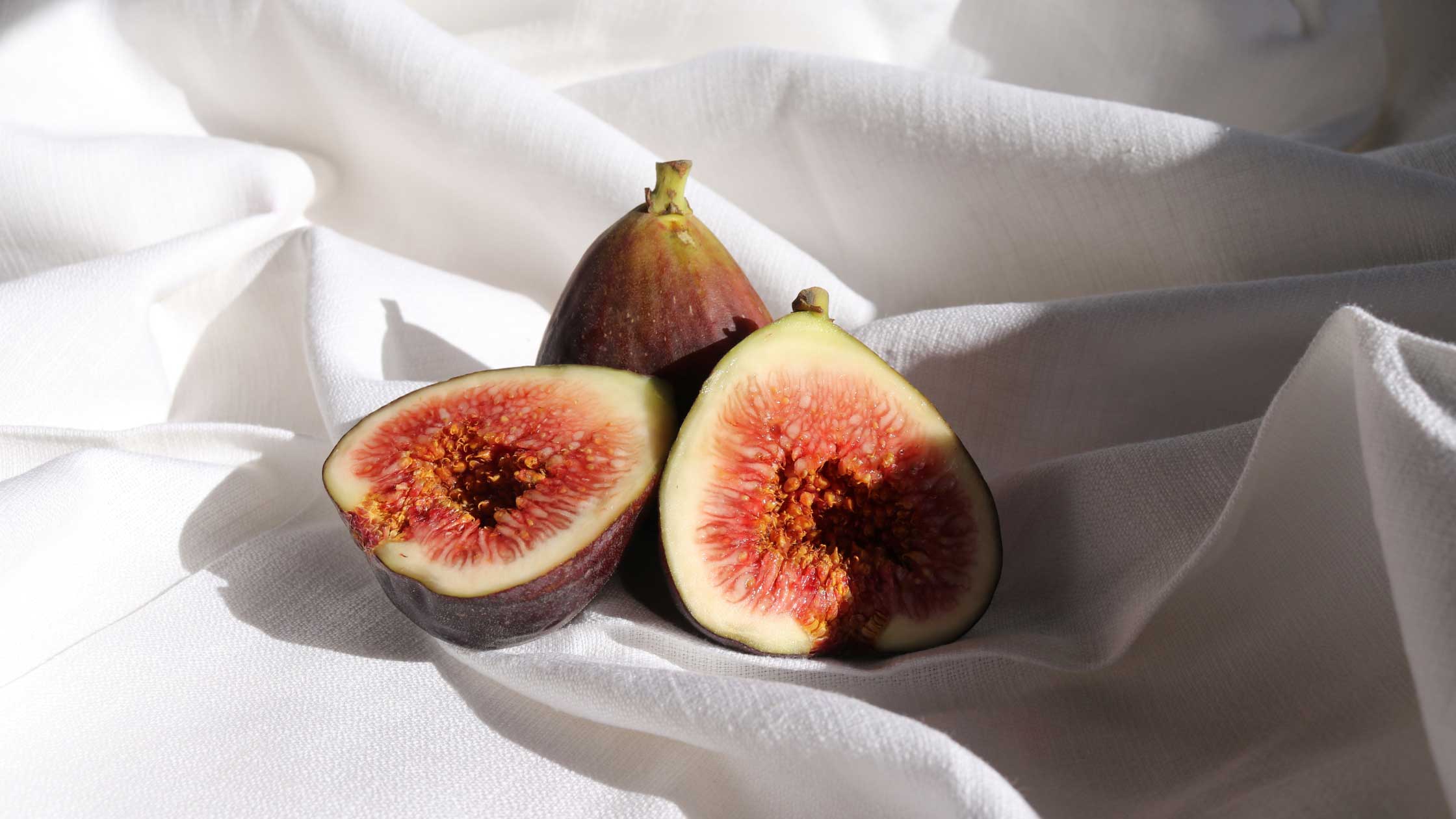 All natural figs in a white sheet.  Figs can increase sex drive. Rich in antioxidants.