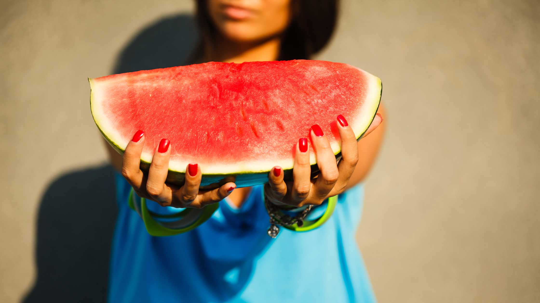 Woman holding a watermelon. Watermelon might improve sex drive.